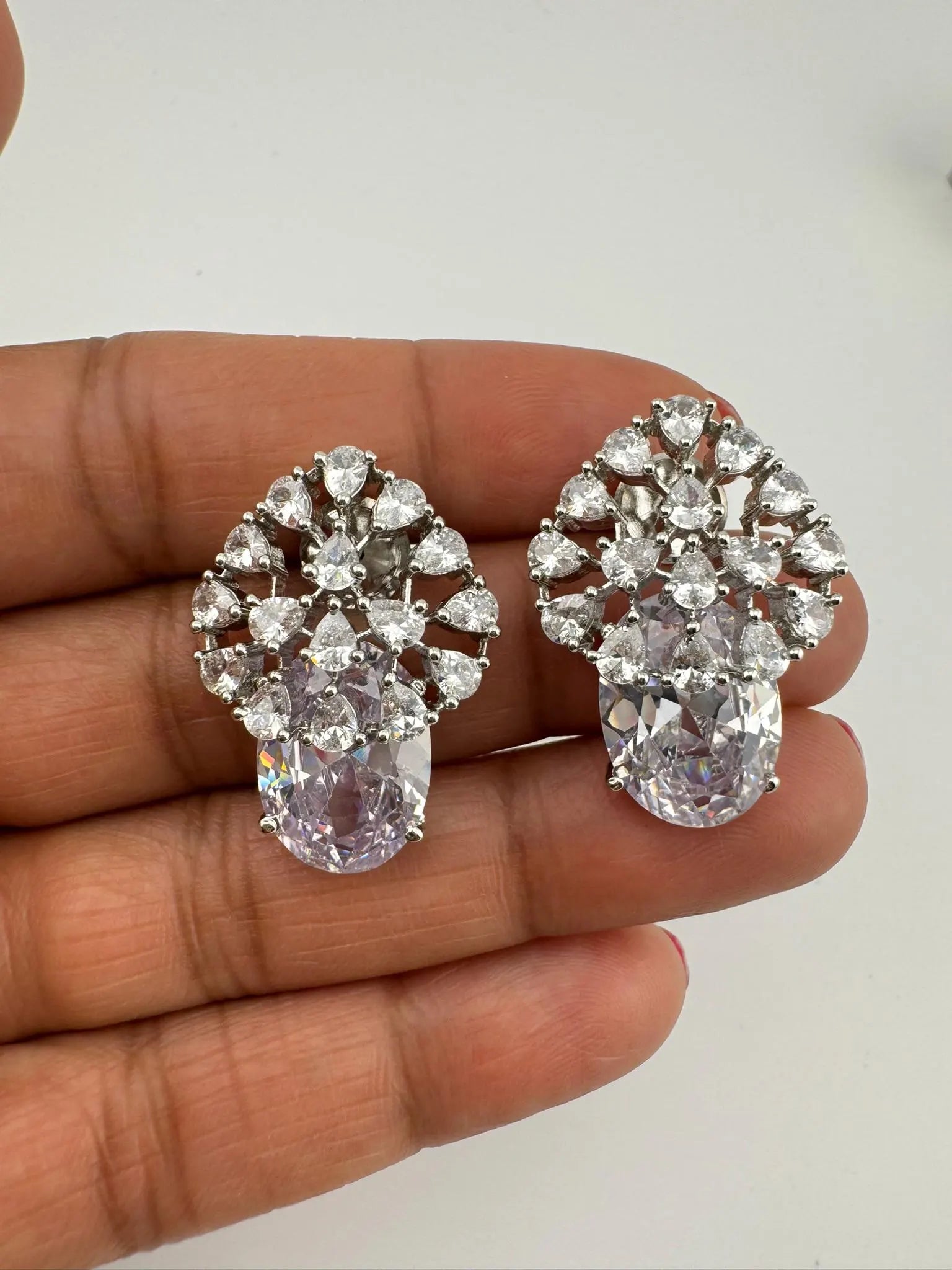 Premium Studs in Cubic Zirconia and Glass stone in silver color is designer Inspired Statement earrings