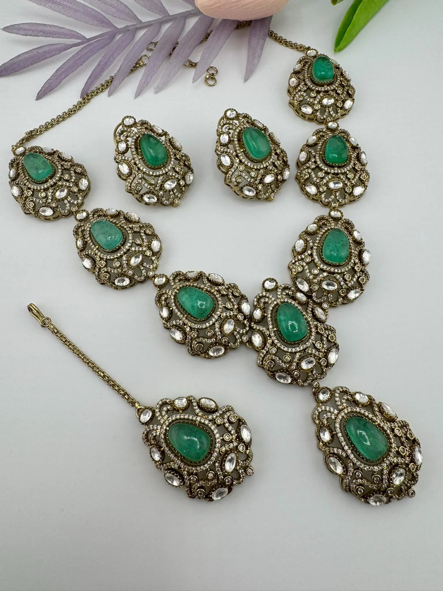 Premium Quality in Moissanite, uncut Kundan, CZ, Doublet stones in matt gold is Designer inspired fusion Necklace with Stud earring & Tikka