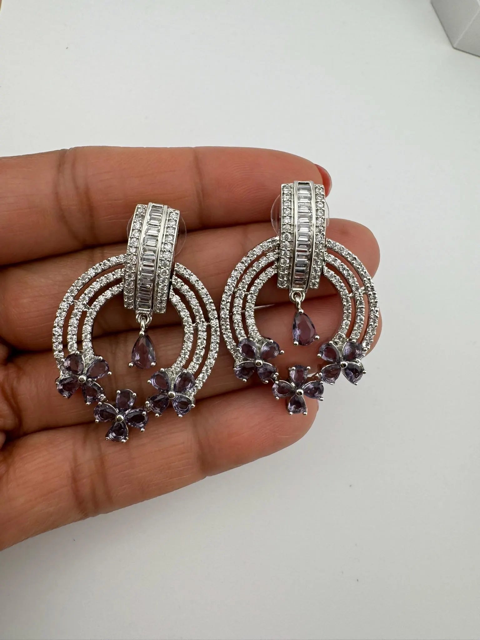 Premium earrings in Cubic Zirconia and Glass stone in silver color is designer Inspired Statement earrings