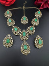 Premium Quality in Moissanite, uncut Kundan, CZ, Doublet stones in matt gold is Designer inspired fusion Necklace with Stud earring & Tikka