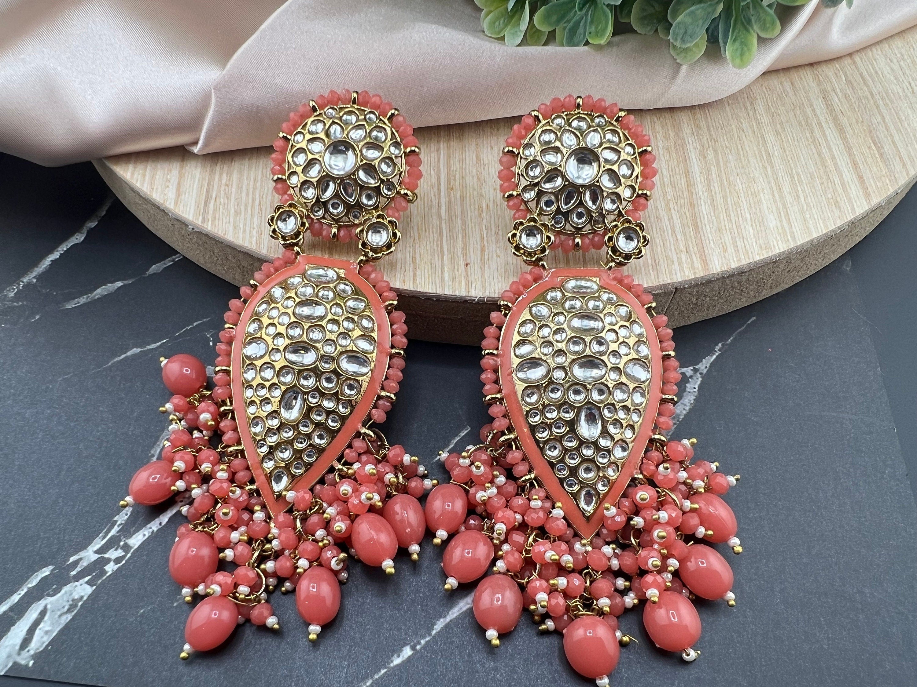 Exquisite detailed Gold and Coral color long Chand Bali Earrings with kundan and pearls
