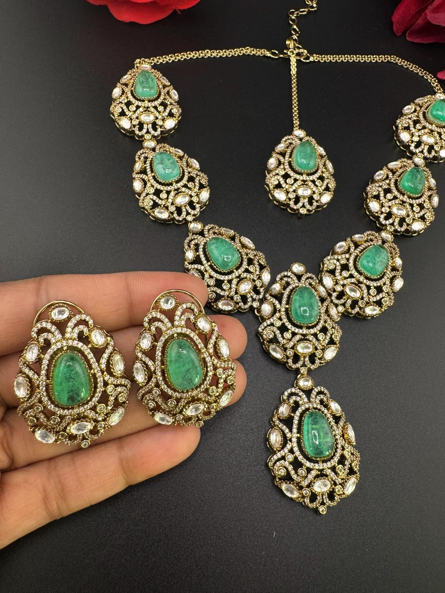 Premium Quality in Moissanite, uncut Kundan, CZ, Doublet stones in matt gold is Designer inspired fusion Necklace with Stud earring & Tikka