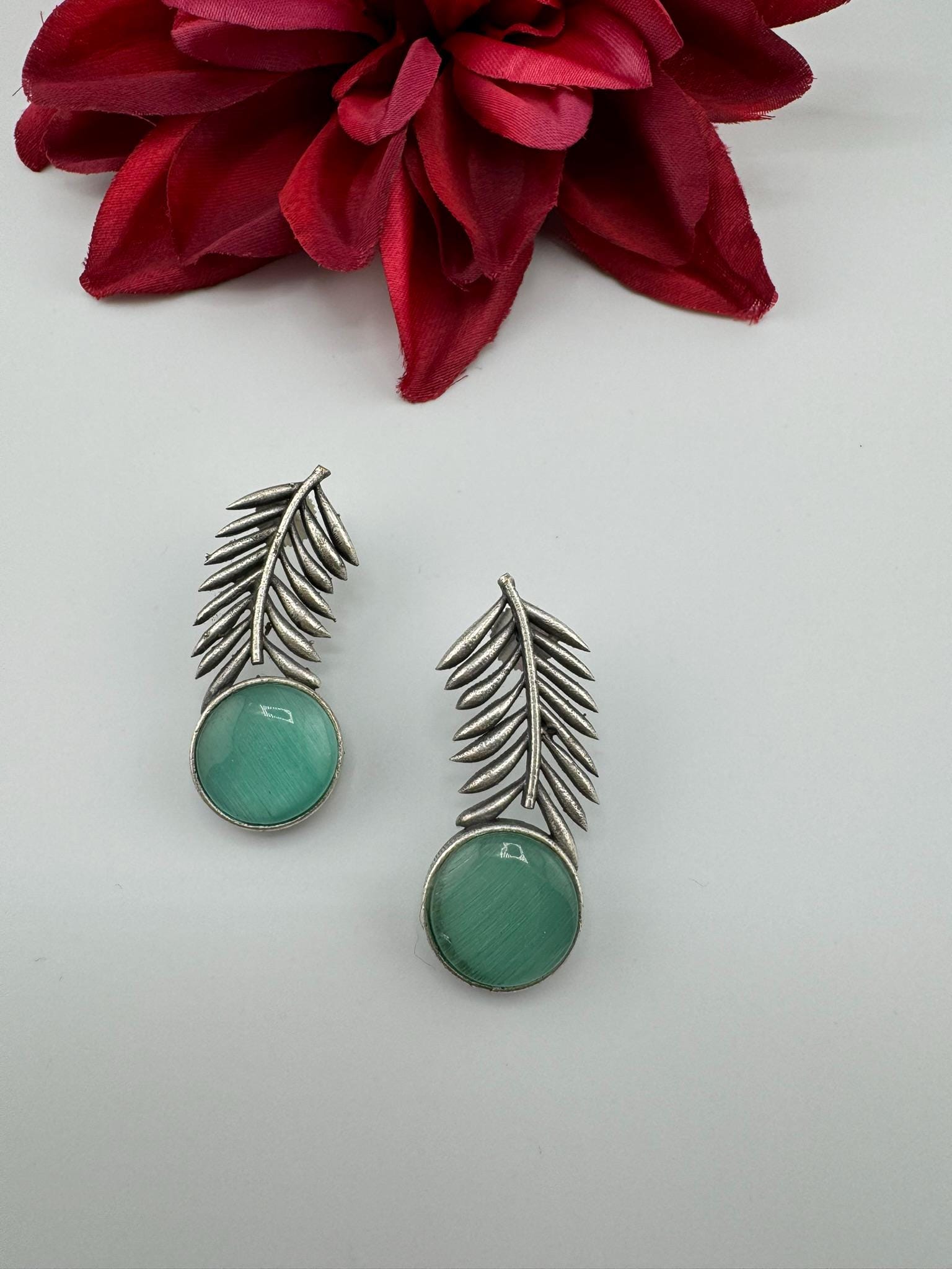 Oxidized German silver leaf pattern Stud earrings with Monalisa stone