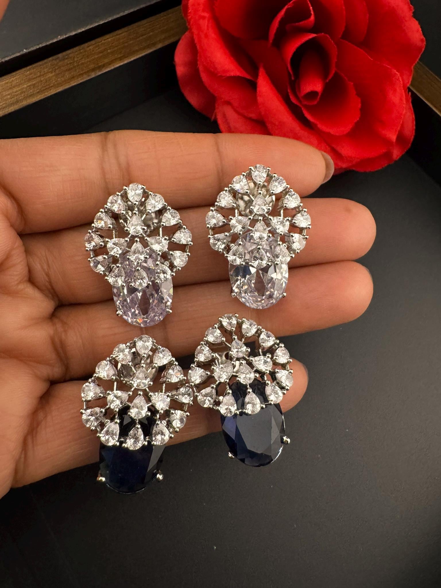 Premium Studs in Cubic Zirconia and Glass stone in silver color is designer Inspired Statement earrings