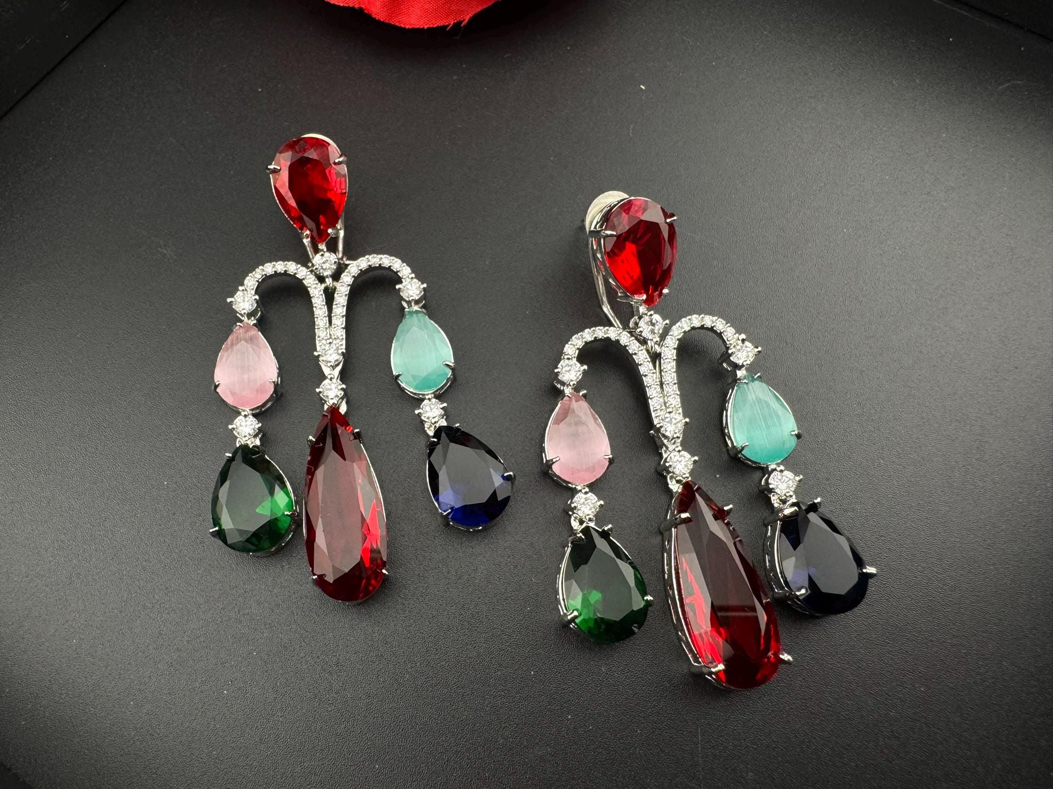 Premium Cubic Zirconia and glass stone in silver color is designer Inspired Statement Long earrings