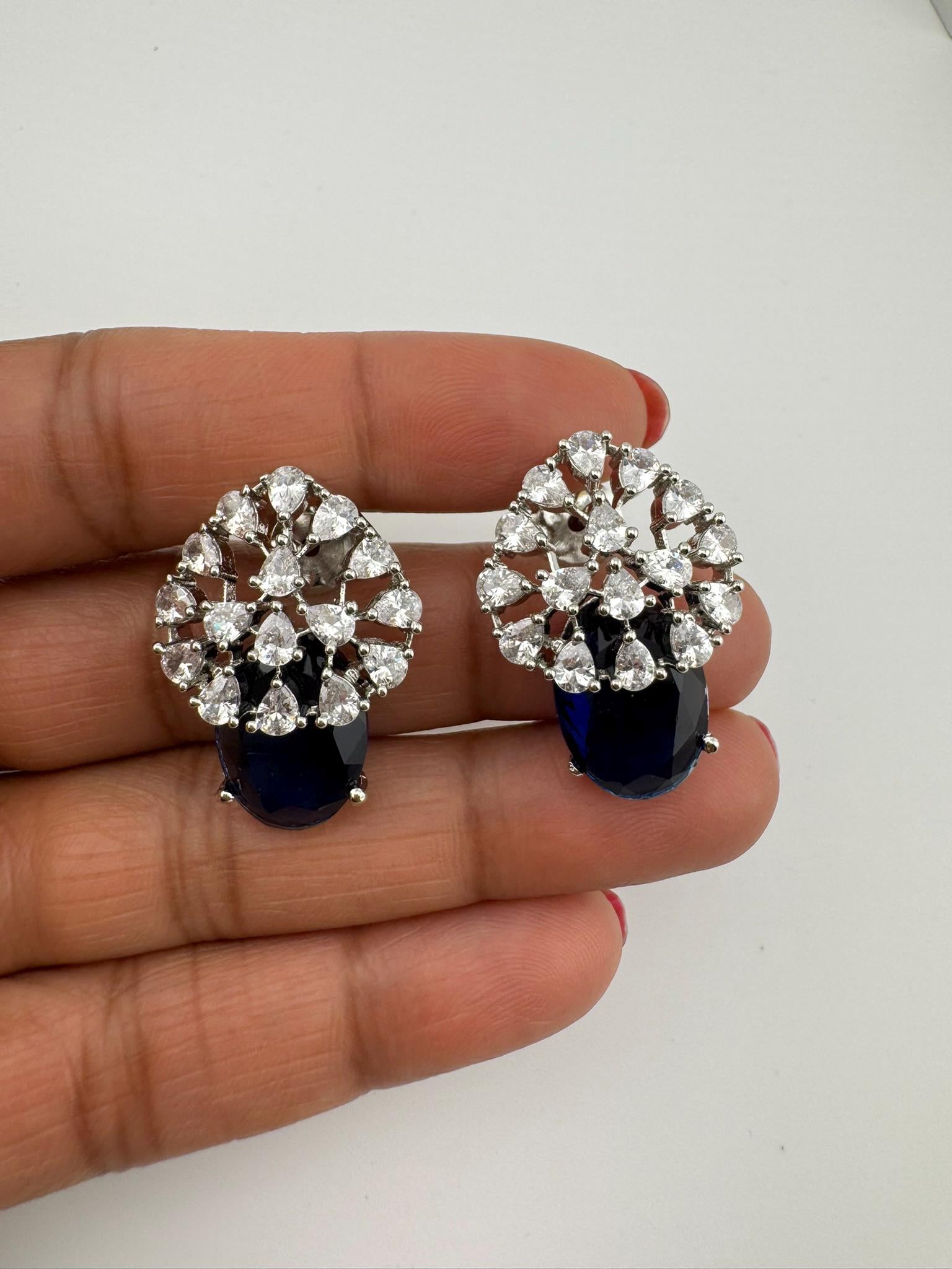 Premium Studs in Cubic Zirconia and Glass stone in silver color is designer Inspired Statement earrings