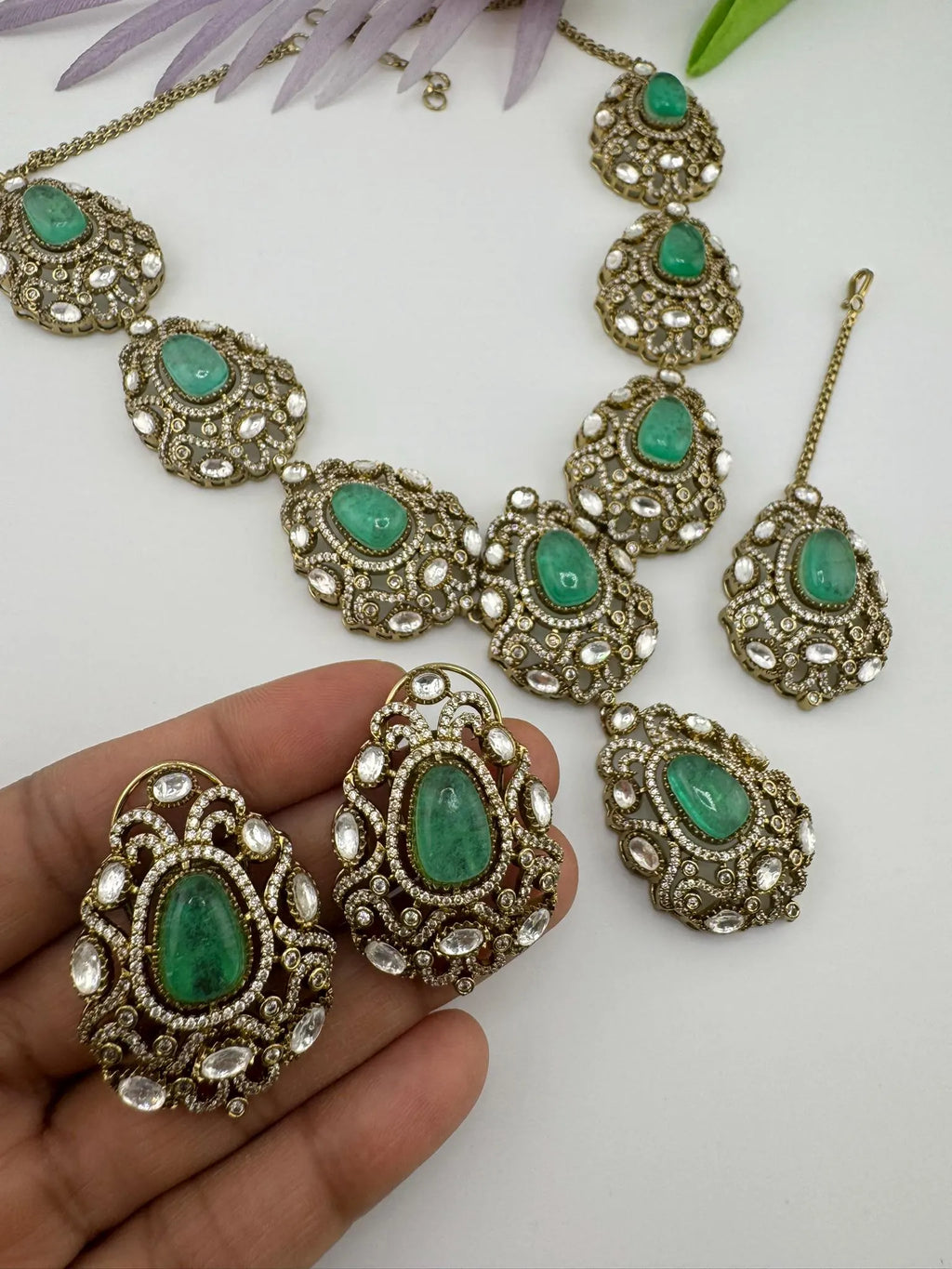 Premium Quality in Moissanite, uncut Kundan, CZ, Doublet stones in matt gold is Designer inspired fusion Necklace with Stud earring & Tikka