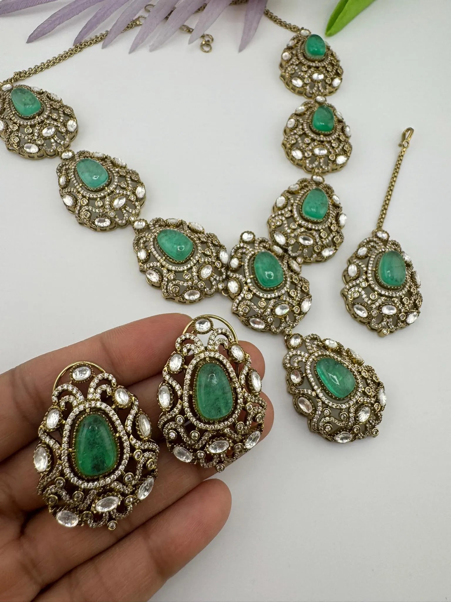 Premium Quality in Moissanite, uncut Kundan, CZ, Doublet stones in matt gold is Designer inspired fusion Necklace with Stud earring & Tikka