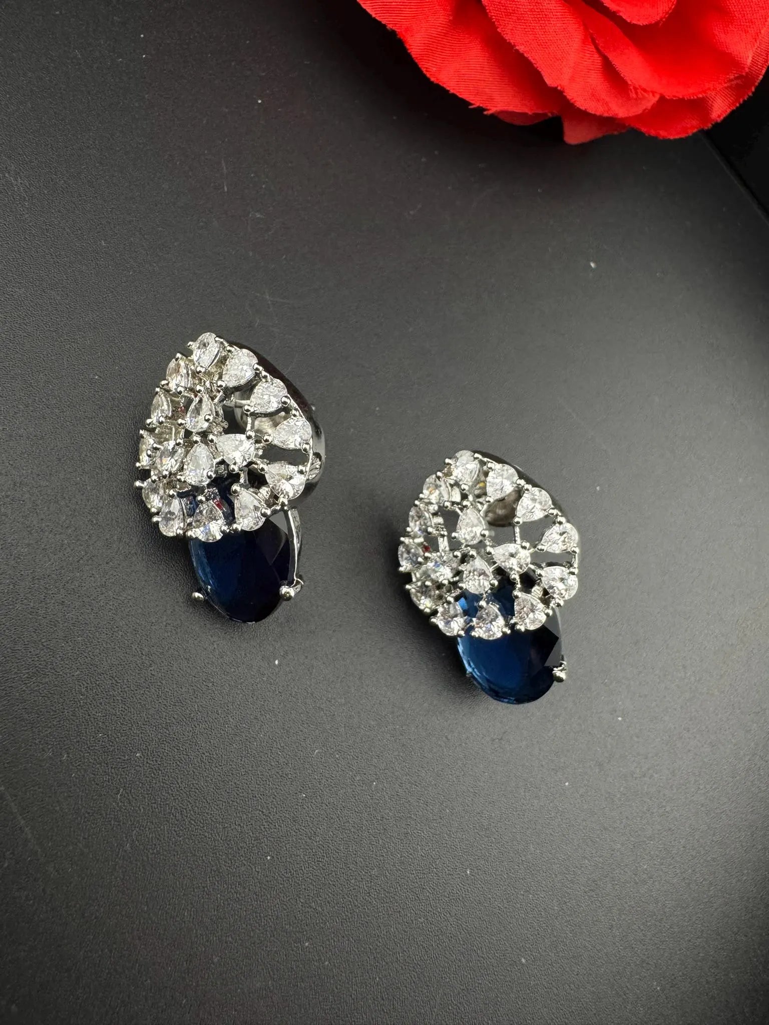Premium Studs in Cubic Zirconia and Glass stone in silver color is designer Inspired Statement earrings