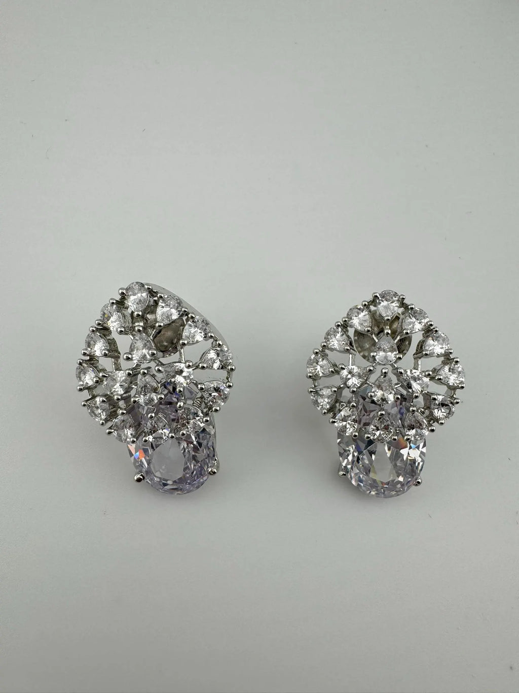 Premium Studs in Cubic Zirconia and Glass stone in silver color is designer Inspired Statement earrings