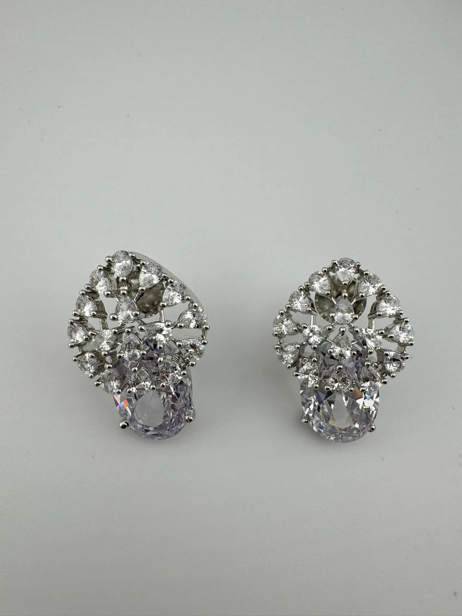 Premium Studs in Cubic Zirconia and Glass stone in silver color is designer Inspired Statement earrings