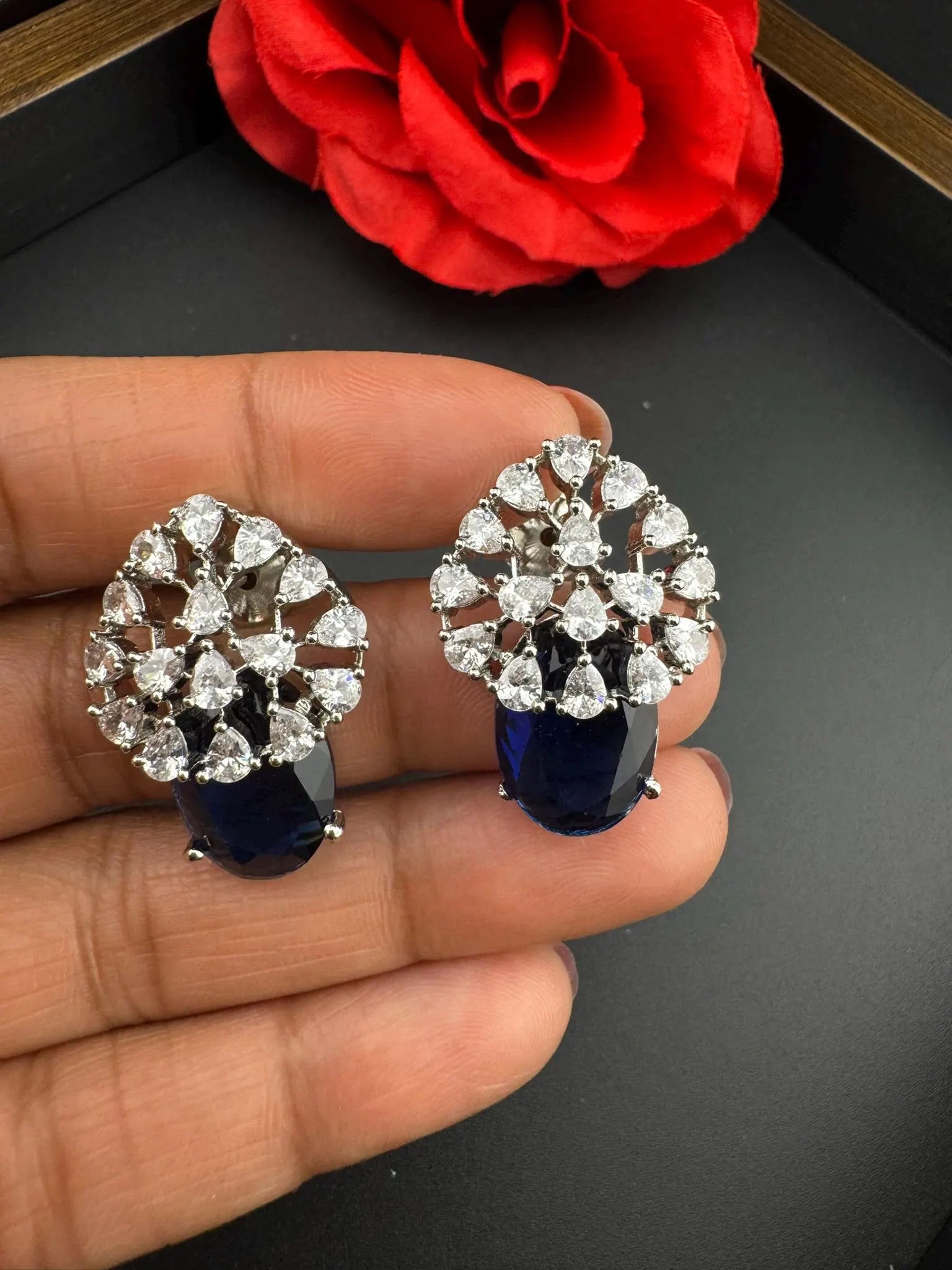 Premium Studs in Cubic Zirconia and Glass stone in silver color is designer Inspired Statement earrings