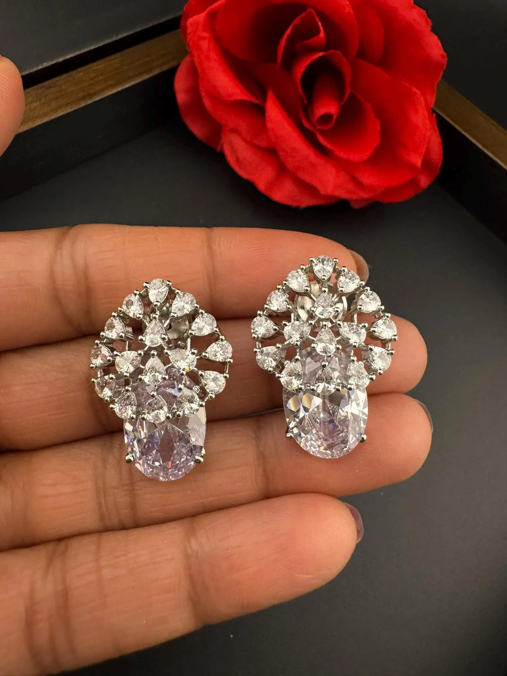 Premium Studs in Cubic Zirconia and Glass stone in silver color is designer Inspired Statement earrings