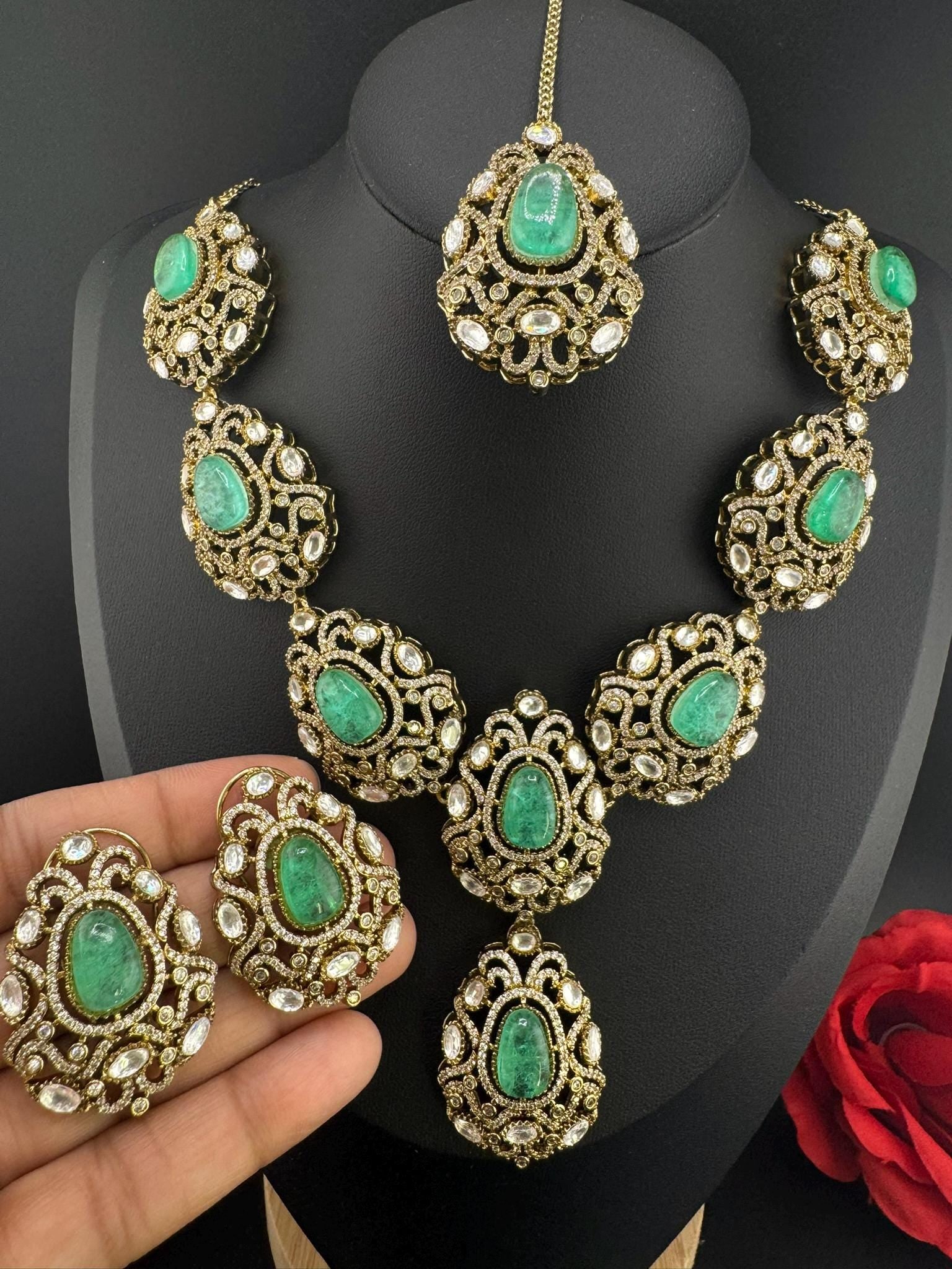 Premium Quality in Moissanite, uncut Kundan, CZ, Doublet stones in matt gold is Designer inspired fusion Necklace with Stud earring & Tikka