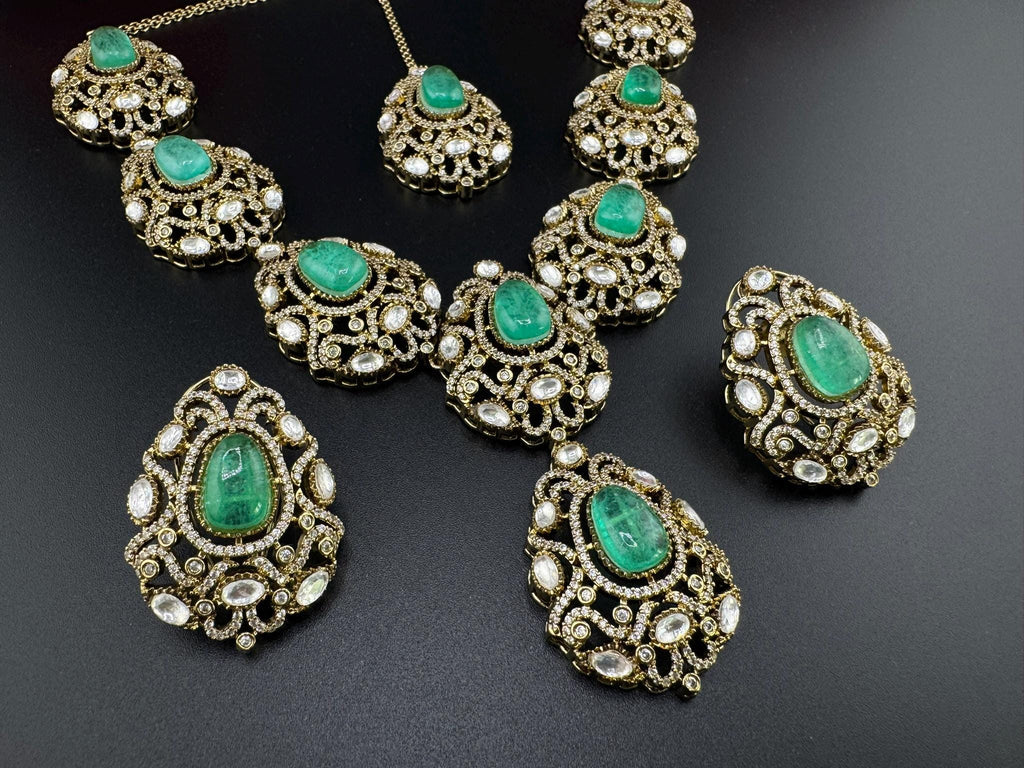 Premium Quality in Moissanite, uncut Kundan, CZ, Doublet stones in matt gold is Designer inspired fusion Necklace with Stud earring & Tikka