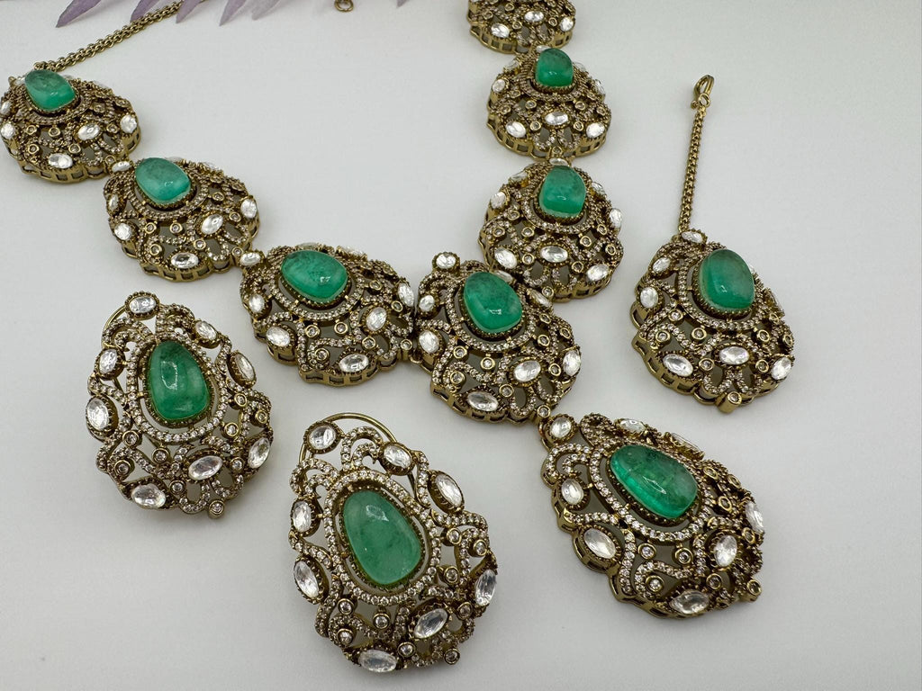 Premium Quality in Moissanite, uncut Kundan, CZ, Doublet stones in matt gold is Designer inspired fusion Necklace with Stud earring & Tikka