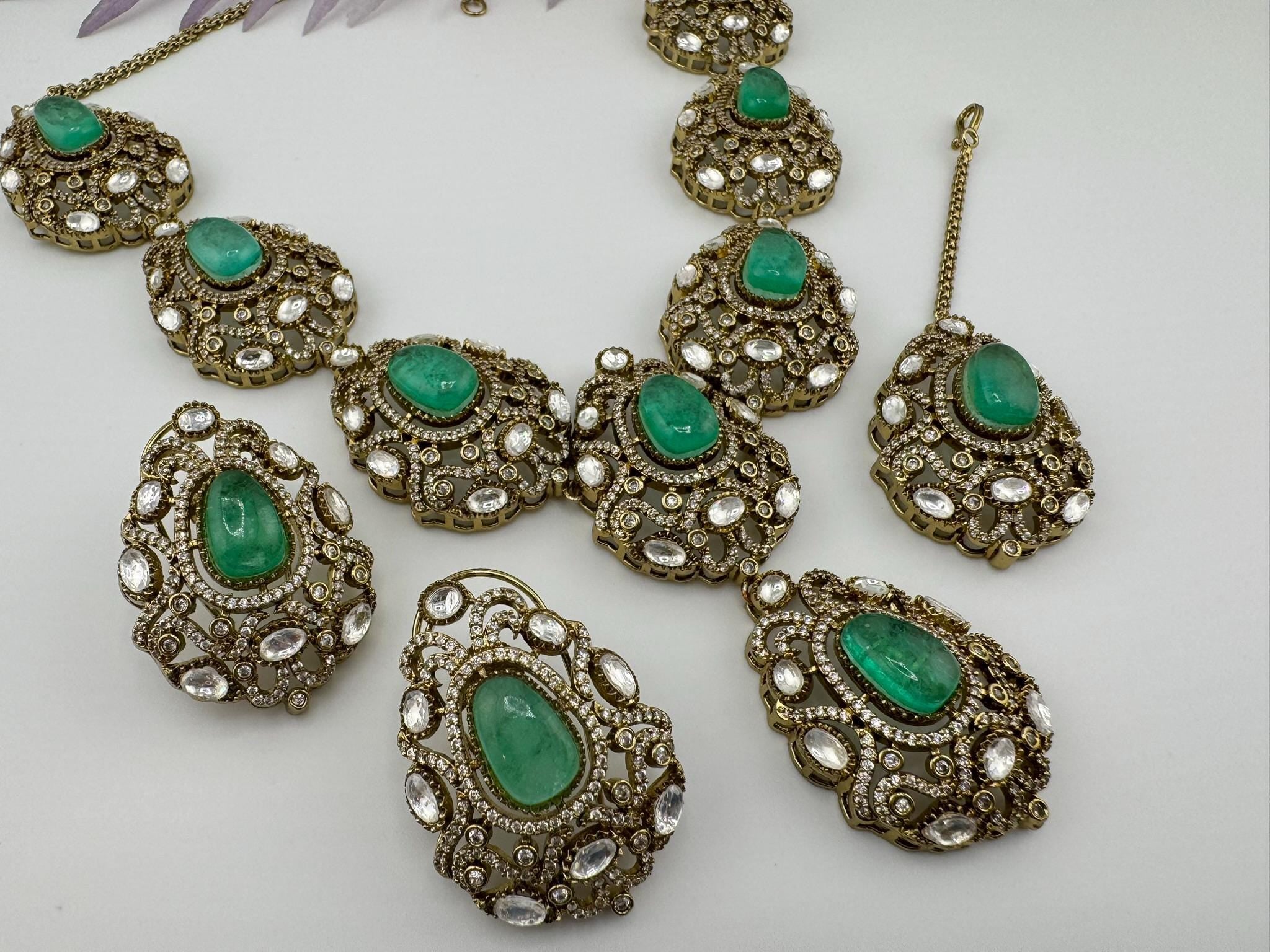 Premium Quality in Moissanite, uncut Kundan, CZ, Doublet stones in matt gold is Designer inspired fusion Necklace with Stud earring & Tikka