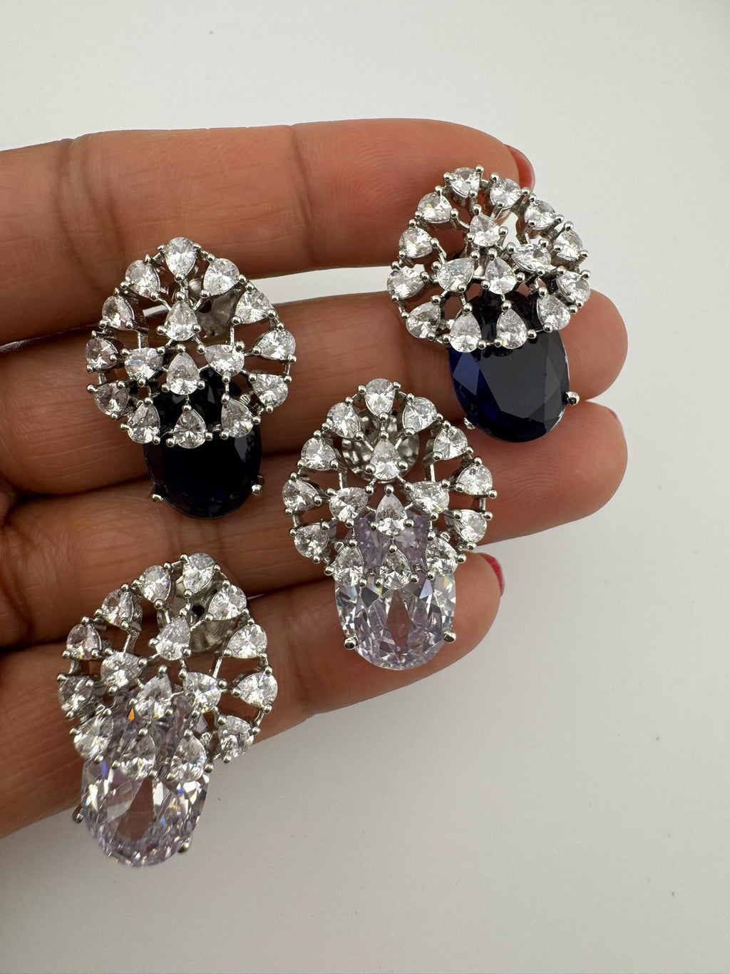 Premium Studs in Cubic Zirconia and Glass stone in silver color is designer Inspired Statement earrings