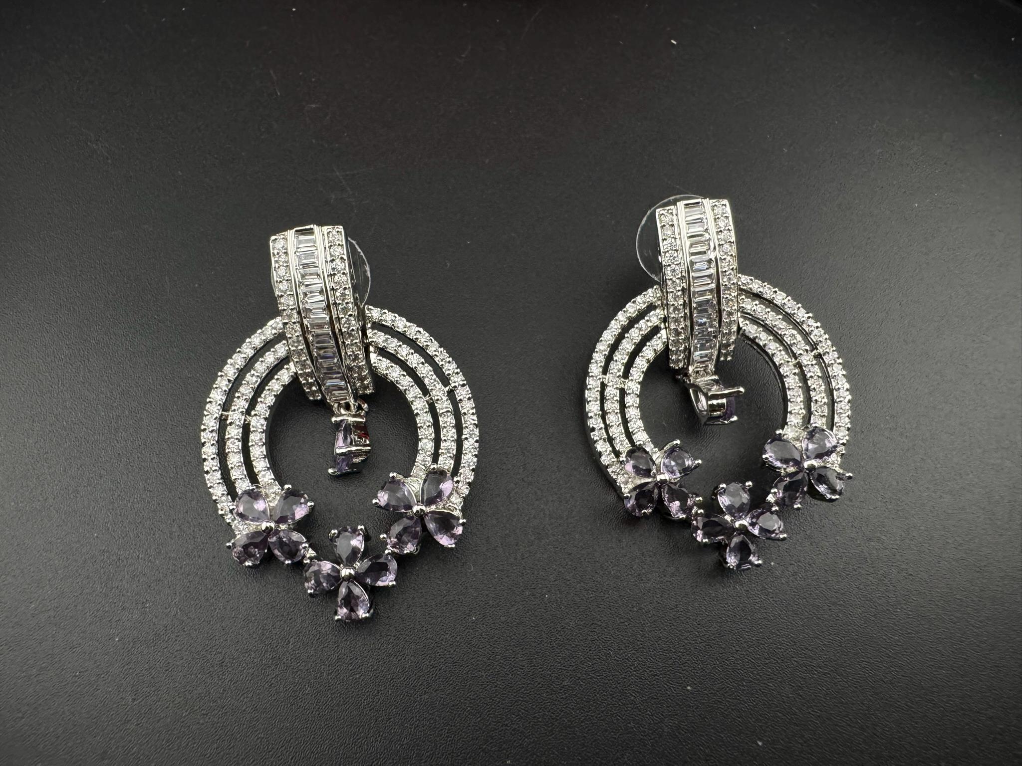 Premium earrings in Cubic Zirconia and Glass stone in silver color is designer Inspired Statement earrings