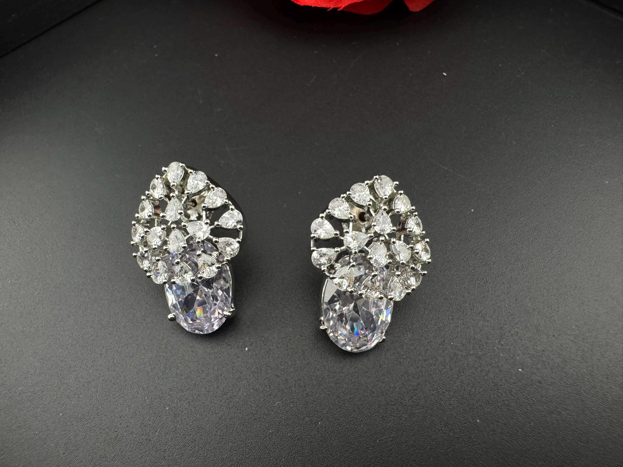 Premium Studs in Cubic Zirconia and Glass stone in silver color is designer Inspired Statement earrings